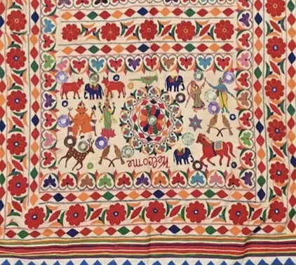 Dense pieced and mirrored Banjara embroidery panel, cream ground worked in heavy floral and animal motifs with a diamond and lotus border.