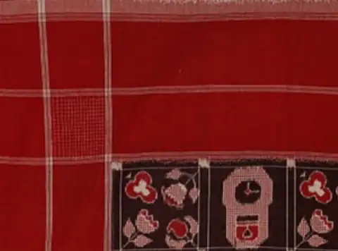 A Telia Rumal double-ikat cotton field in oil-treated red, black, and white, with checked bands and flower and clock cells.